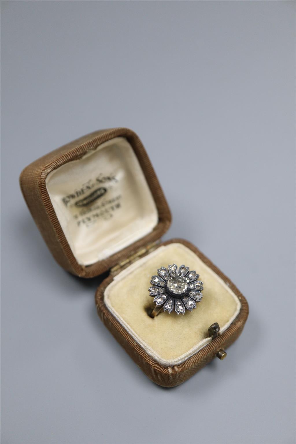 An antique yellow metal and diamond set circular cluster ring, (adapted?), size K/L, gross 3.5 grams,